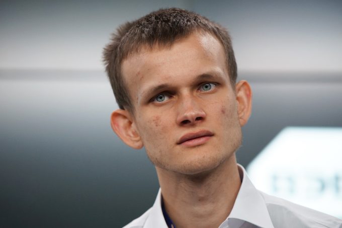 A close-up portrait of Vitalik Buterin, the co-founder of Ethereum. The image is used in an article that discusses his new thesis on how "boring" DeFi (Decentralized Finance) can play a crucial role in securing Ethereum's future.