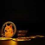 A physical, gold-colored Dogecoin, featuring the Shiba Inu "Doge" meme, is prominently displayed among other coins on a dark surface. The image represents the popular cryptocurrency, which is the subject of a 2025 article about its recent price movements and market activity.