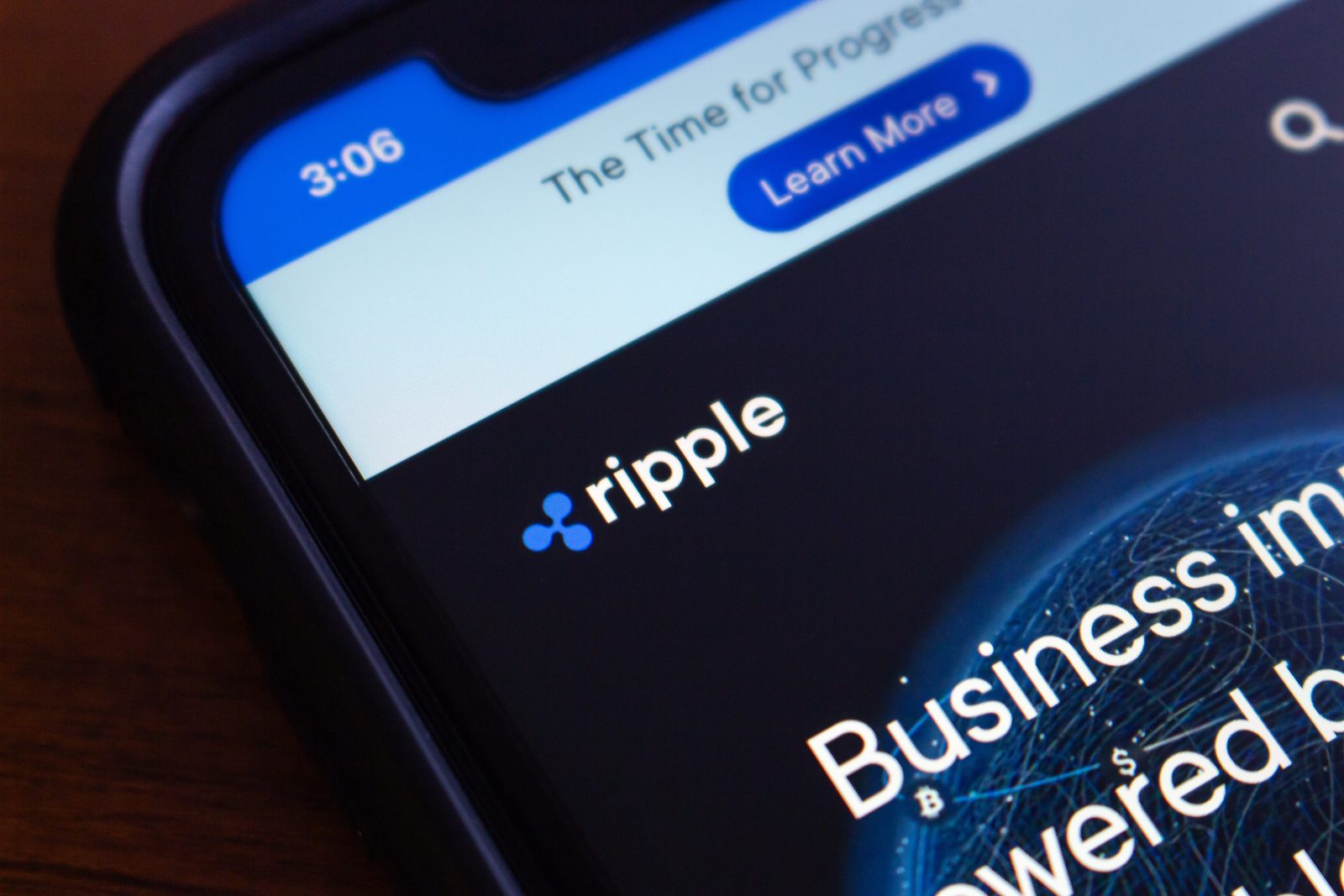 A close-up of the Ripple logo displayed on a smartphone screen. The image identifies the company at the center of the October 2025 article, where its executive is refuting the "crypto as crime" narrative by highlighting public ledger traceability.