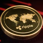 A physical Ripple (XRP) coin is pictured against a dramatic red background with downward-trending charts and arrows, symbolizing a flash crash. The image provides context for the October 12, 2025 article detailing XRP's subsequent recovery and reclaiming of a key support level.