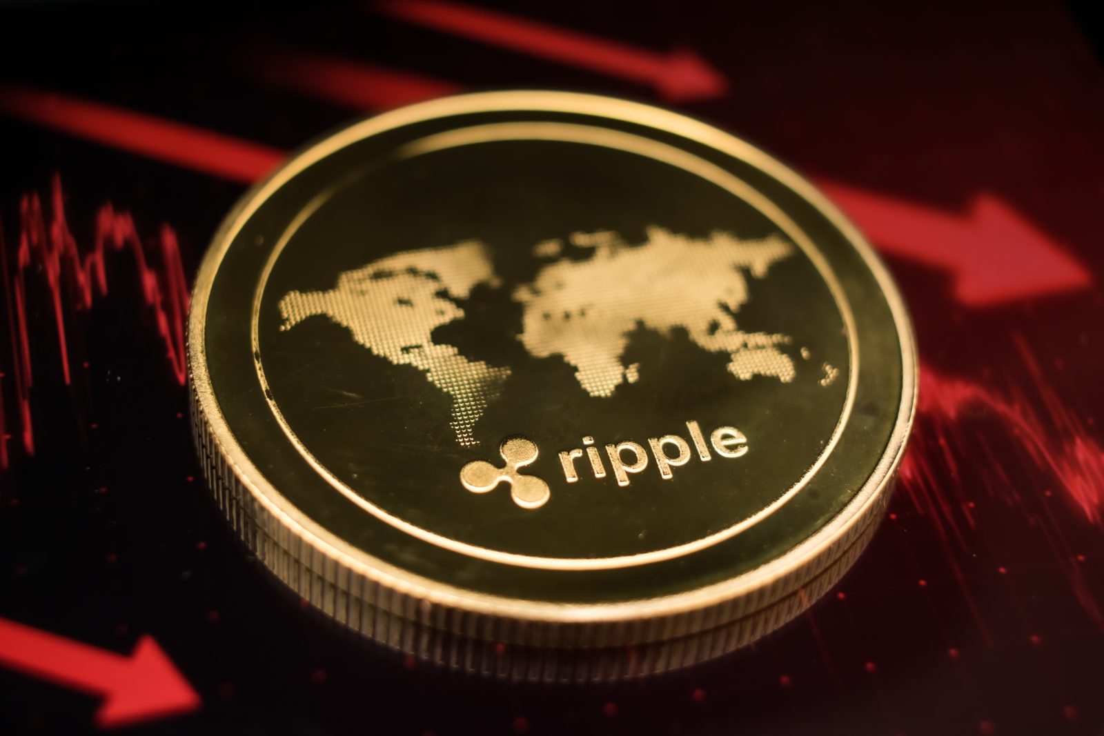 A physical Ripple (XRP) coin is pictured against a dramatic red background with downward-trending charts and arrows, symbolizing a flash crash. The image provides context for the October 12, 2025 article detailing XRP's subsequent recovery and reclaiming of a key support level.