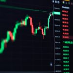 A close-up of a digital cryptocurrency trading chart displaying red and green candlesticks against a dark background.