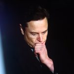 Portrait of Elon Musk, CEO of Tesla and SpaceX, in a professional setting.